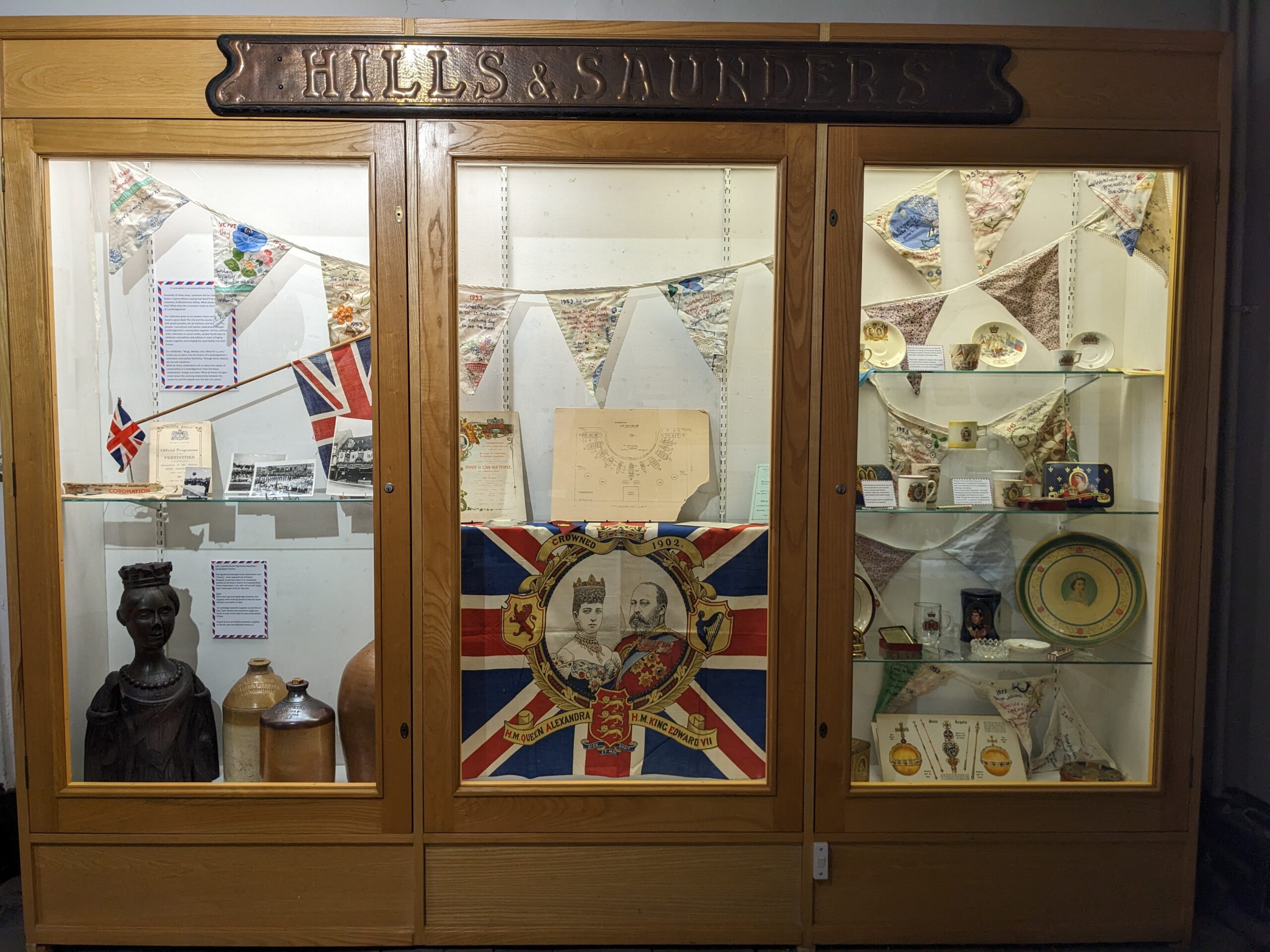 A display cabinet with the Mugs, Medals and a Meal for 15,000 display.