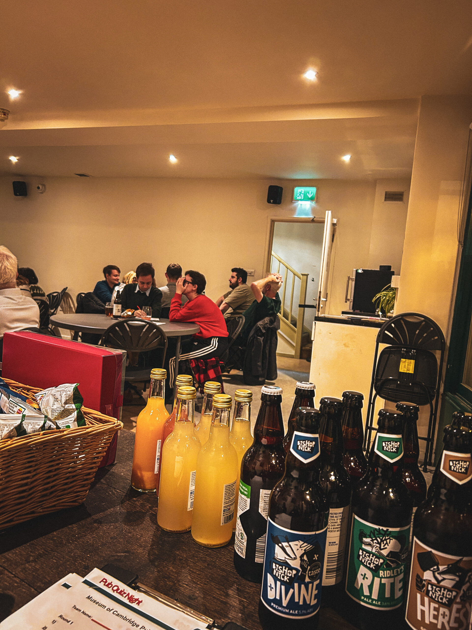 Photo from Museum of Cambridge pub quiz showing participants and drinks donated by Bishop Nick Brewery and The Cambridge Juice Company