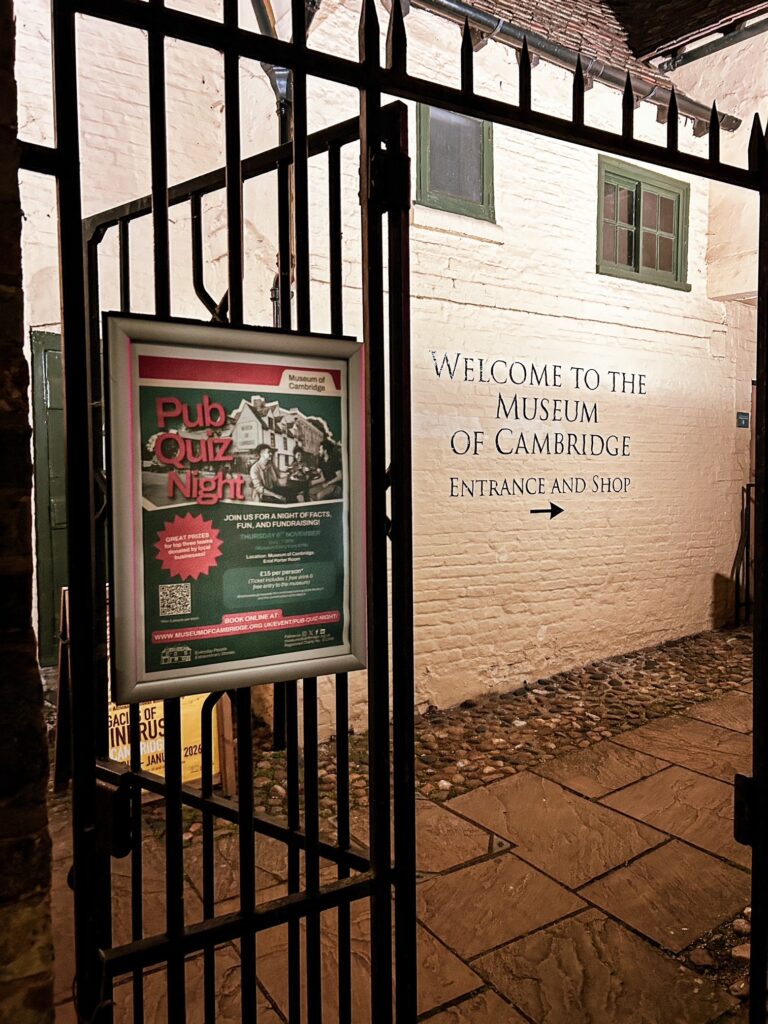 Photo of museum pub quiz poster on the railings outside of the museum