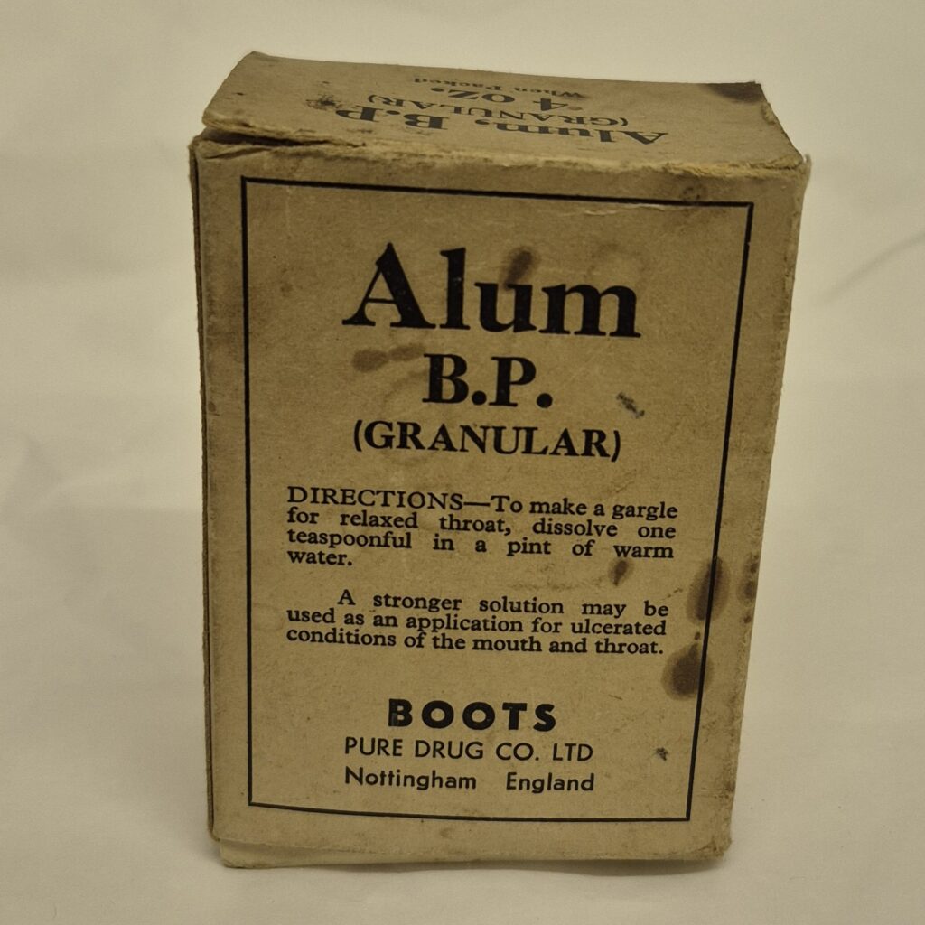 Worn cream rectangular box with black writing that reads 'Alum B.P. (Granular) along with directions for use and the Boots logo.
