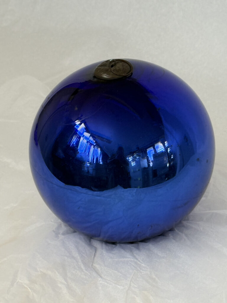 Vivid blue reflective glass ball with metallic loop fixture on the top,
