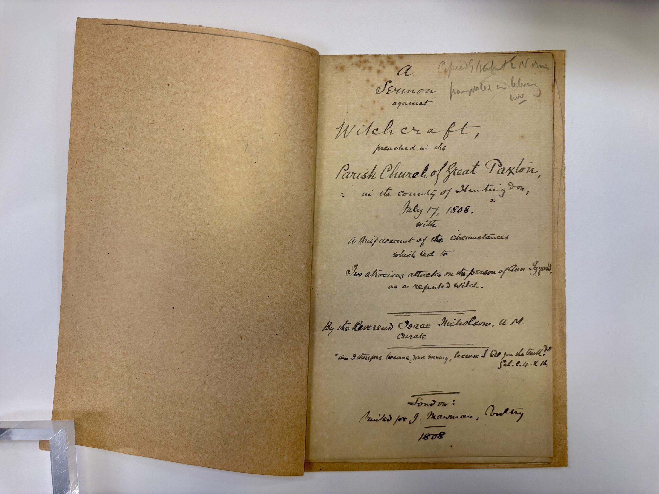 An open book with old, yellowed pages. The left-side page is blank. The right-side page has handwritten text in black calligraphy.

The text reads: 'a Sermon against Witchcraft, preached in the parish church of Great Paxton in the county of Huntingdon, July 17, 1808.